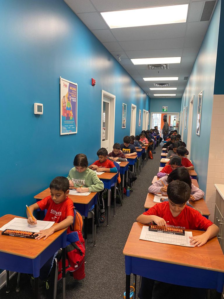 UCMAS Canada students solving maths using abacus.