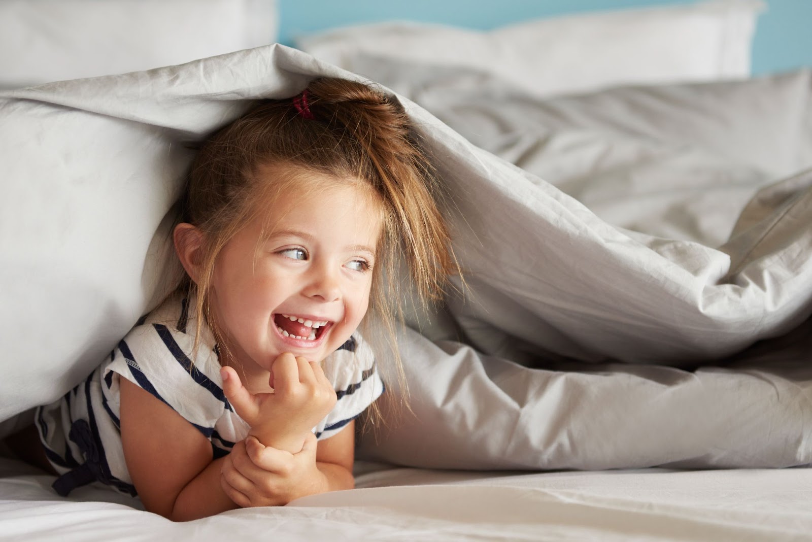 happy kid on bed