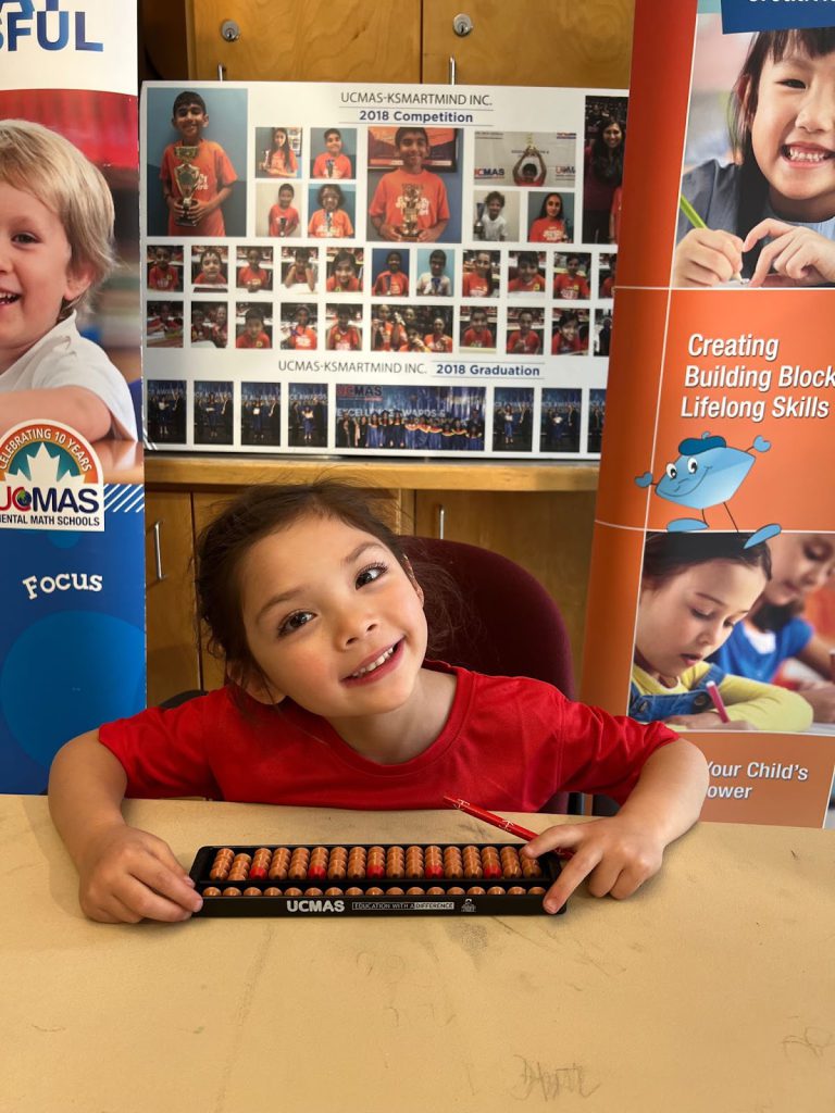MAS Student holding Abacus